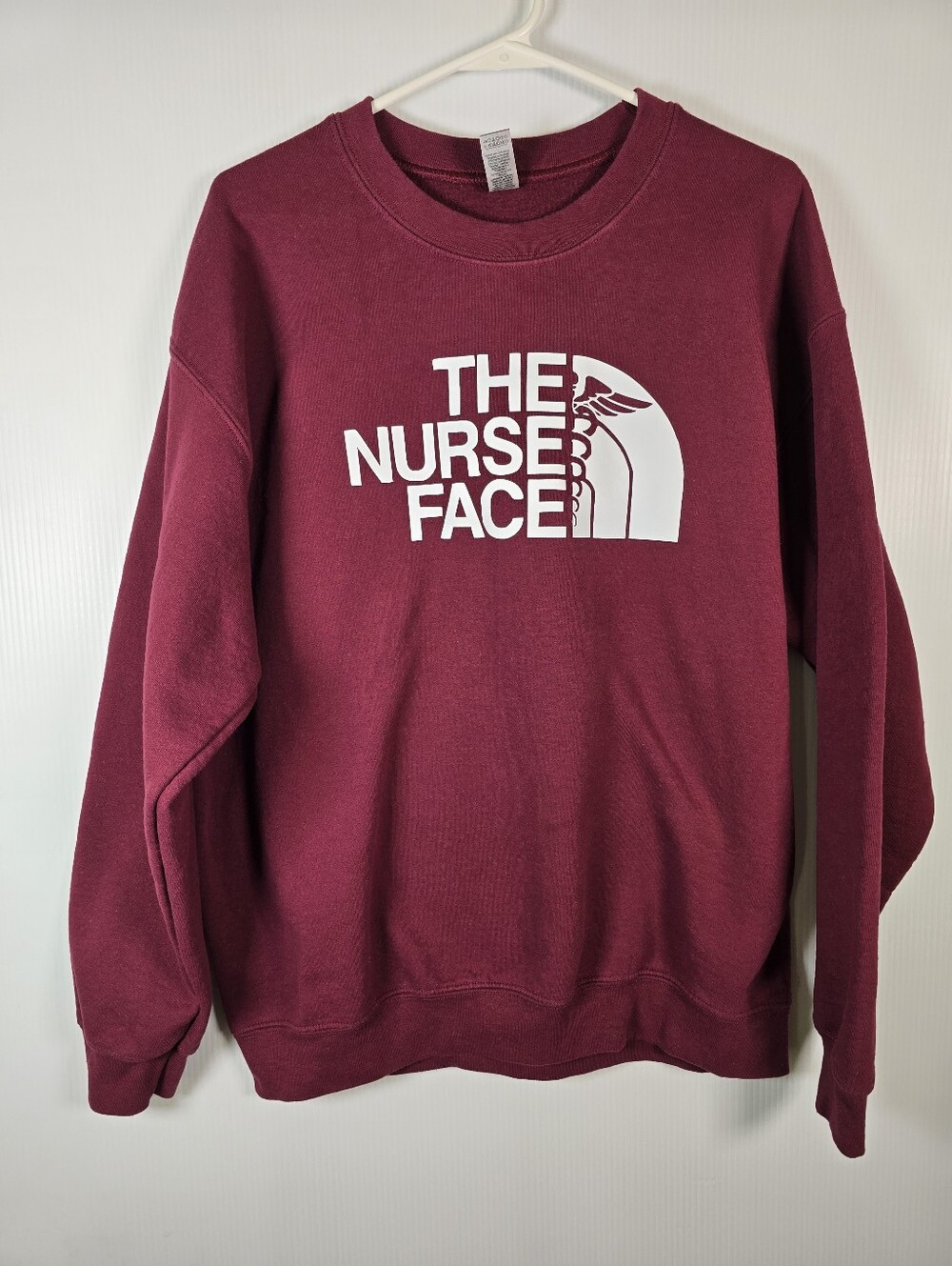 The Nurse Face On A Gildan Cotton/Poly Crewneck Sweatshirt Burgundy&White Size L